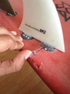 A super ding, broken and delaminated glass.